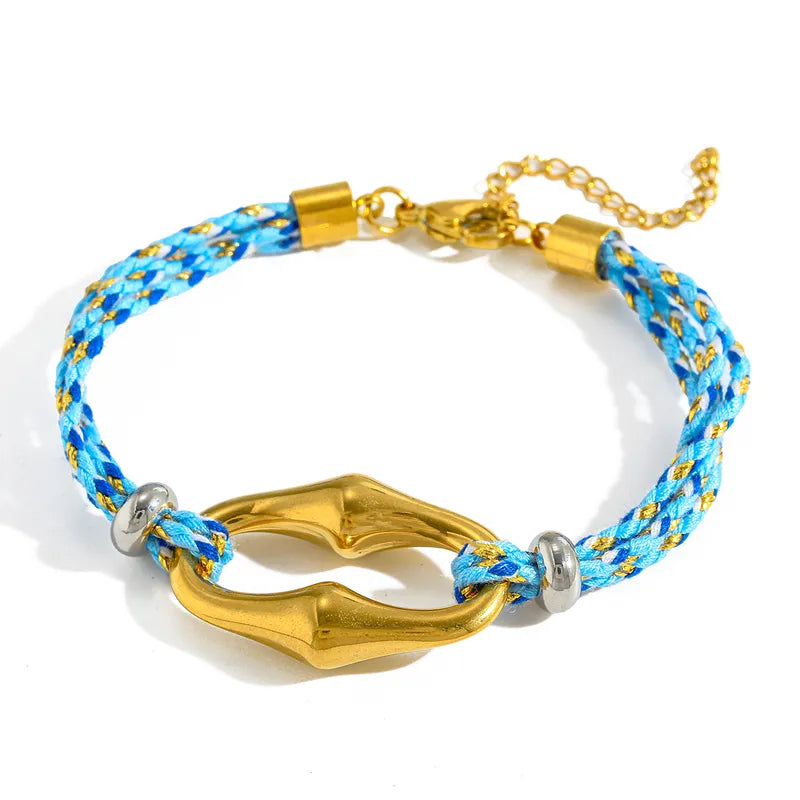 Bracelet with blue and yellow rope and gold clasp on a white background